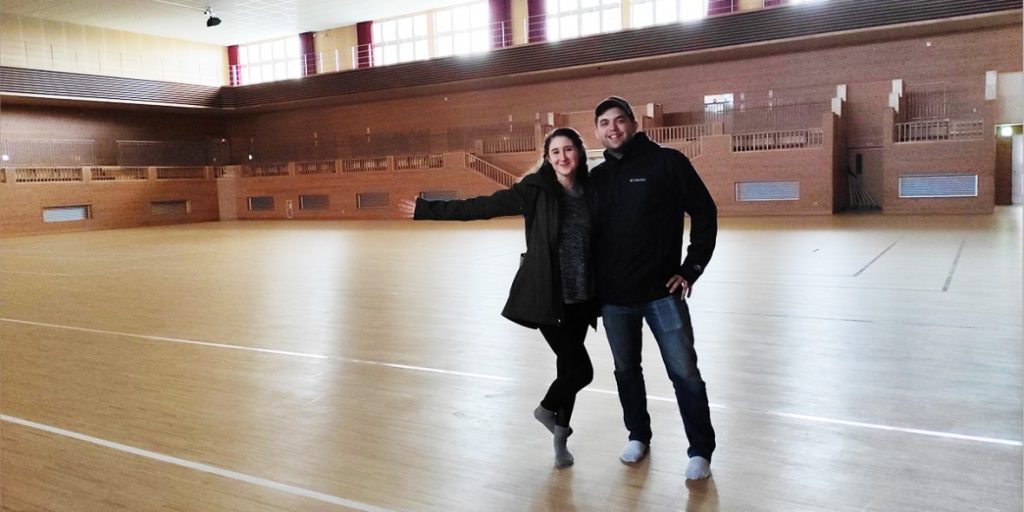 Two visitors in an Okinawan training hall on a history tour