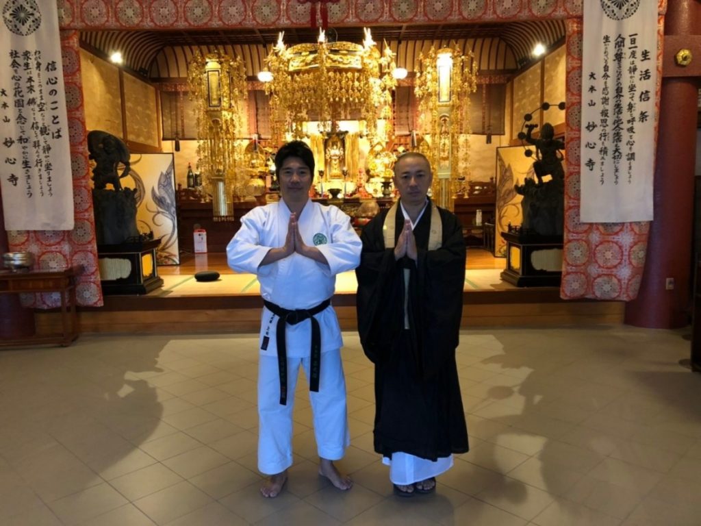 Karate student and a Zen monk at a temple altar