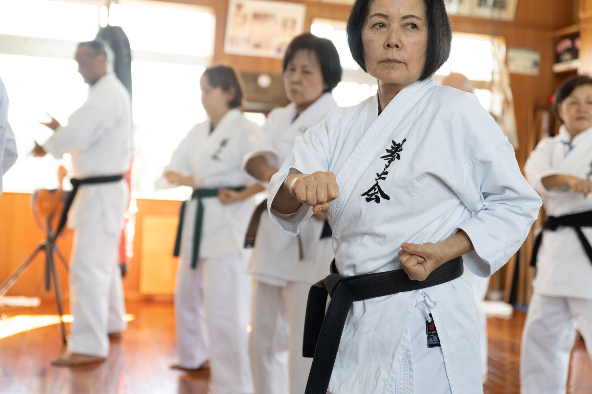 Women's karate class practising punches in an Okinawan dojo