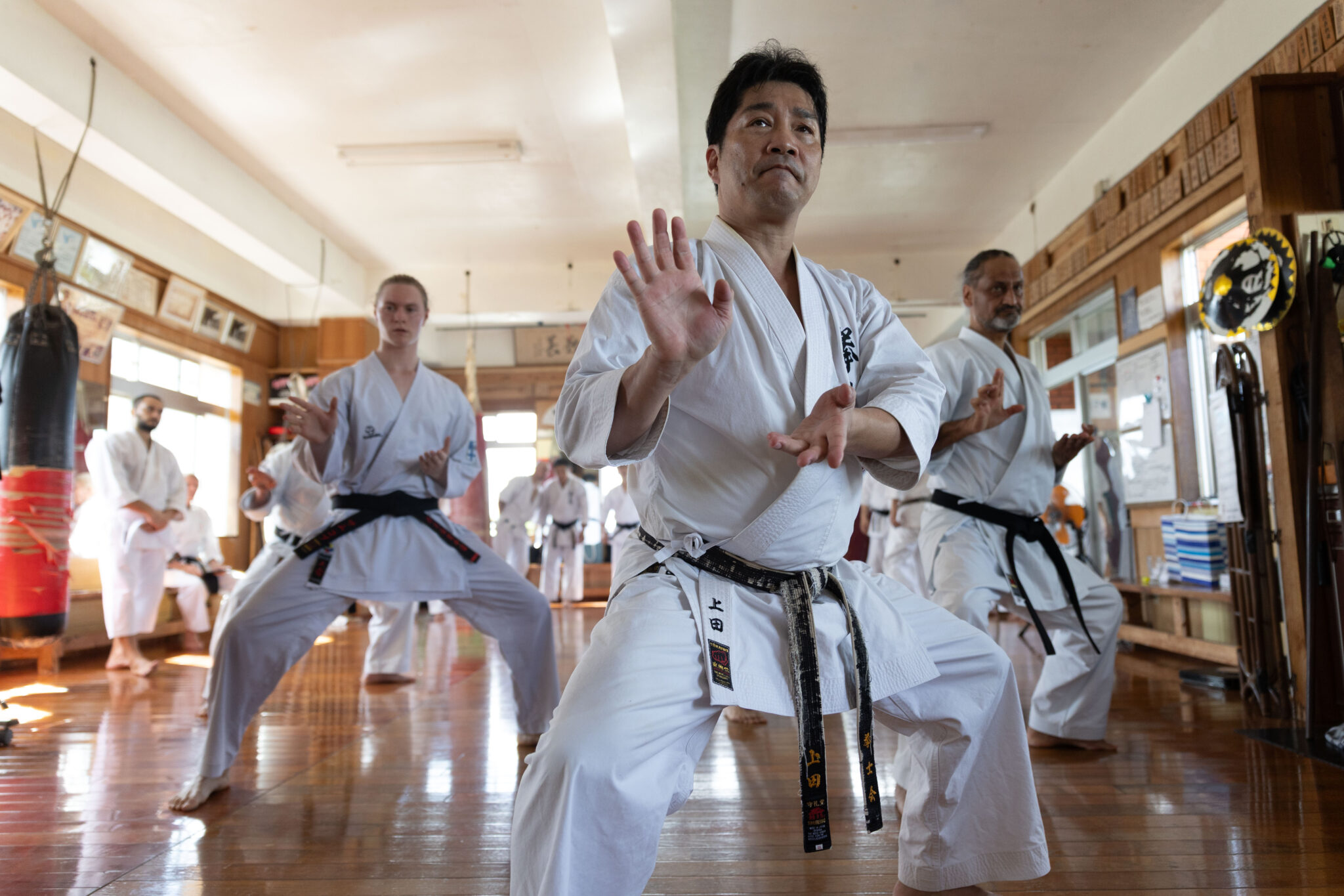 Karate group training with an instructor in an Okinawan dojo