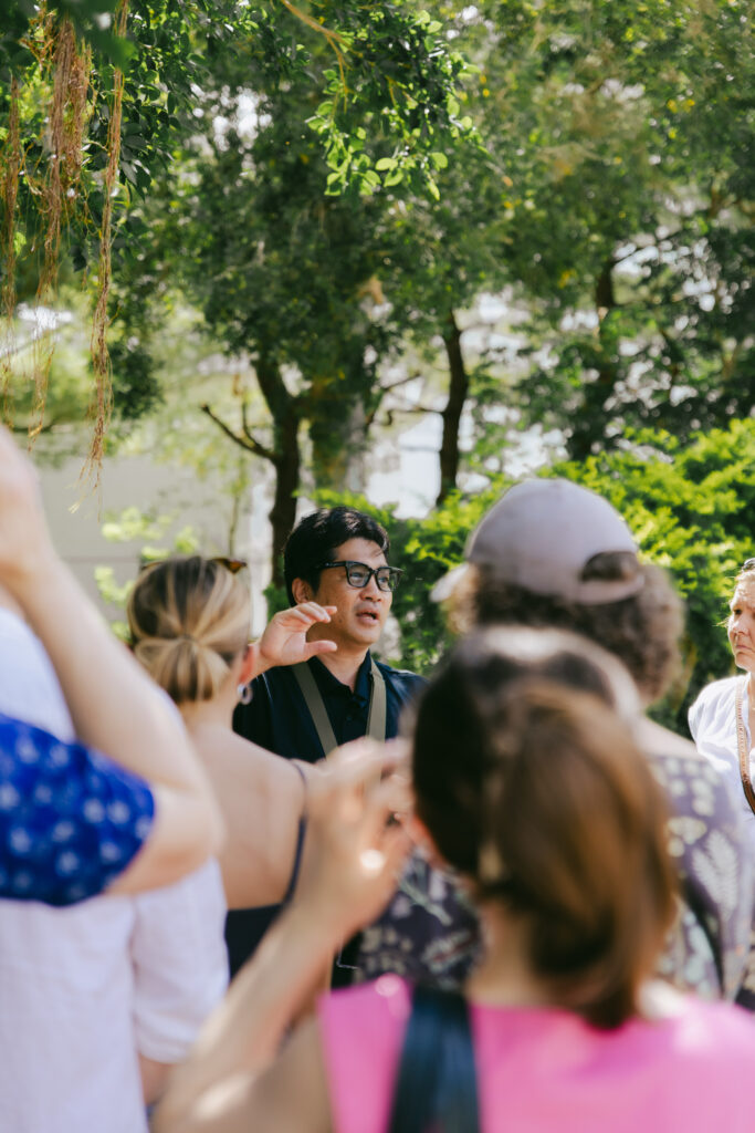 Tour group listening to a guide outdoors in Okinawa