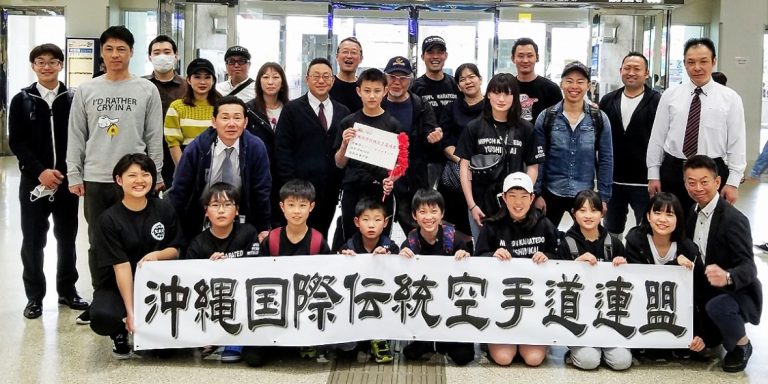 Funakoshi Sensei camp participants with an Okinawa karate federation banner