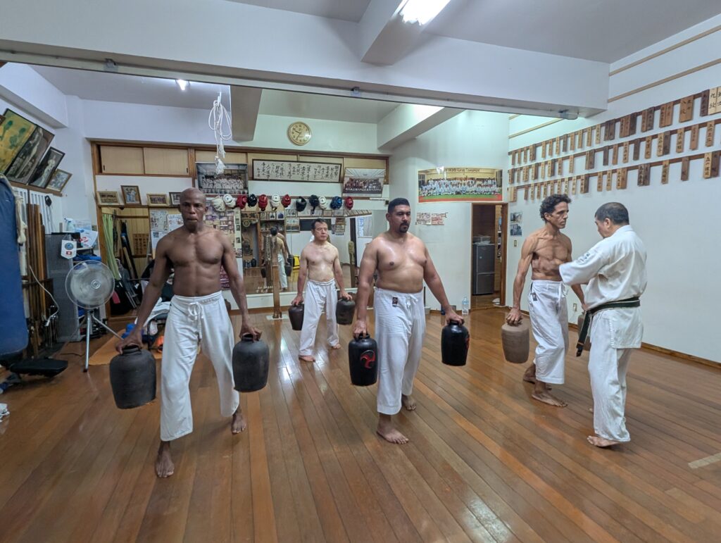 Students doing hojo undo strength training with nigiri-game jars