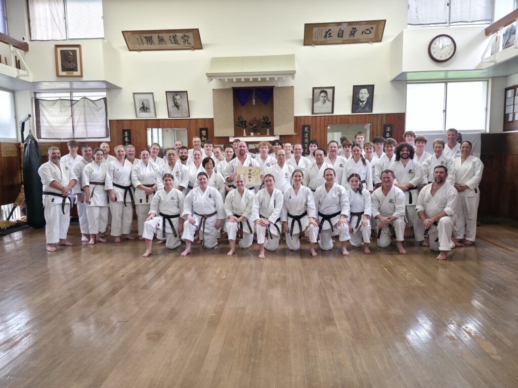 Karate tour group photo in a traditional Okinawan dojo