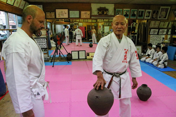 Takashi Kinjo Sensei with nigiri-game jars and a student in the Kobukai dojo