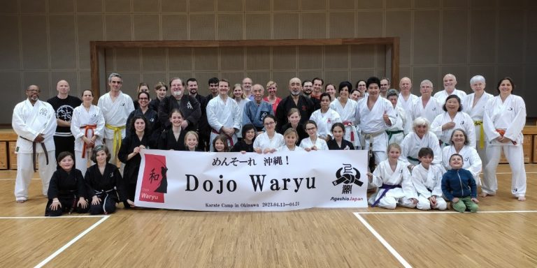 Dojo Waryu group with their banner at a karate camp in Okinawa, 2023
