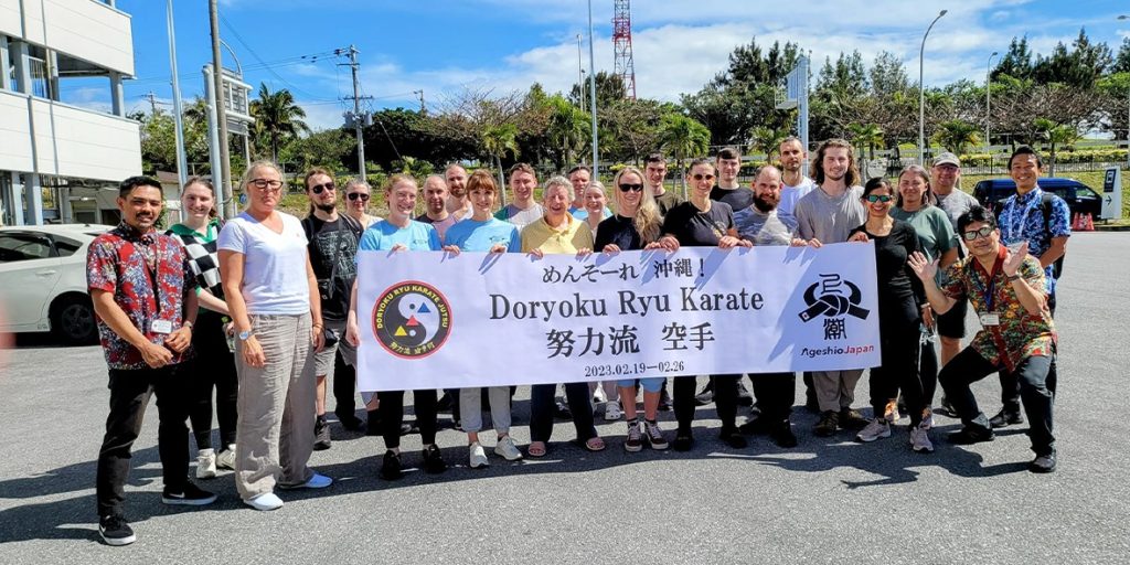 Doryoku Ryu Karate group with their banner in Okinawa, 2023