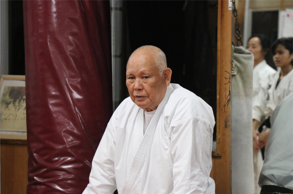 Yoshimasa Kakazu Sensei seated in his dojo