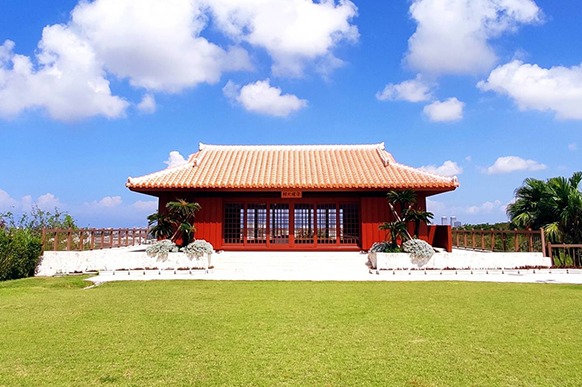 Traditional red dojo building at the Okinawa Karate Kaikan